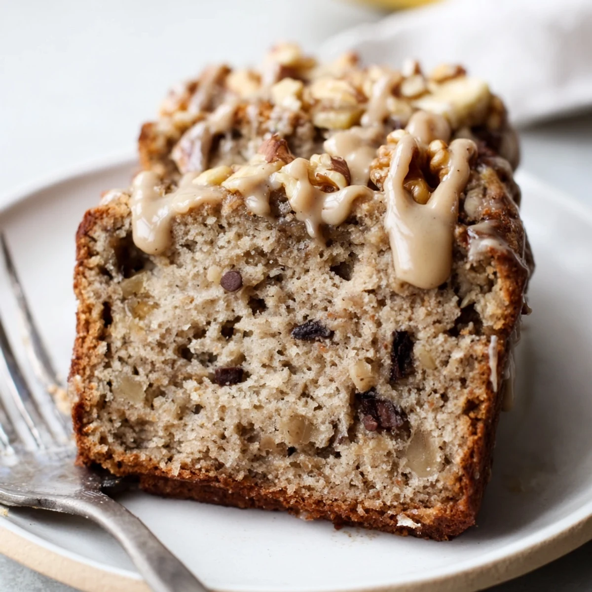 Sliced coffee cream banana bread on a plate, showcasing its rich flavors and texture.
