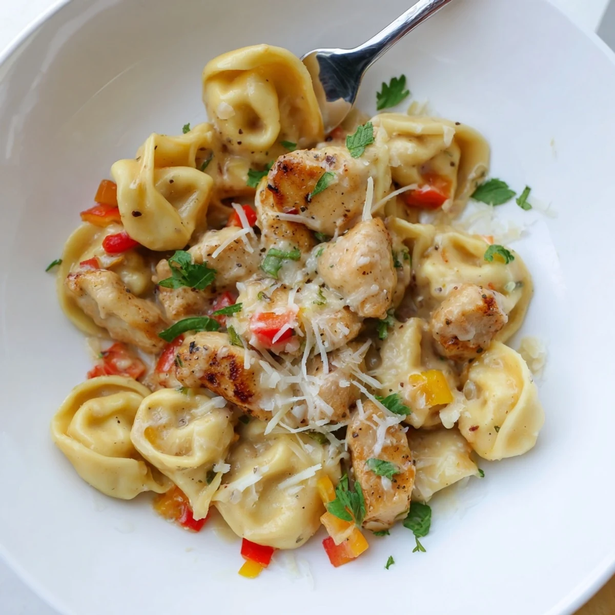 Close-up of Zesty Cajun Garlic Parmesan Chicken Tortellini topped with fresh parsley garnish  