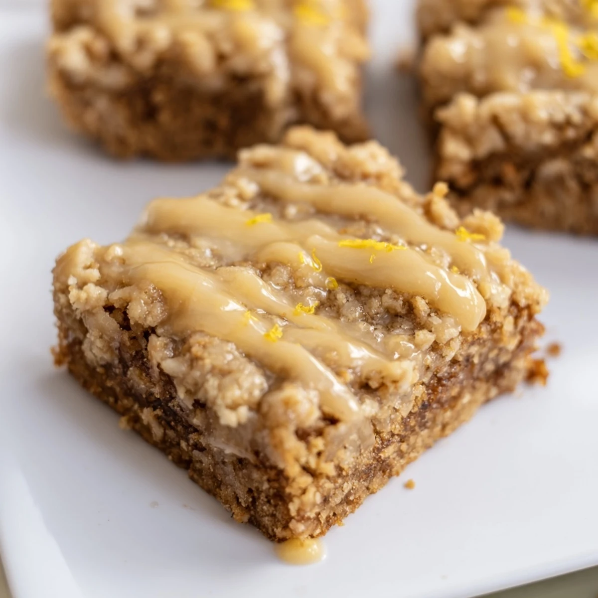 Golden, crumbled topping over warm Lemon-Glazed Gingerbread Crumble Bars, perfect holiday dessert.