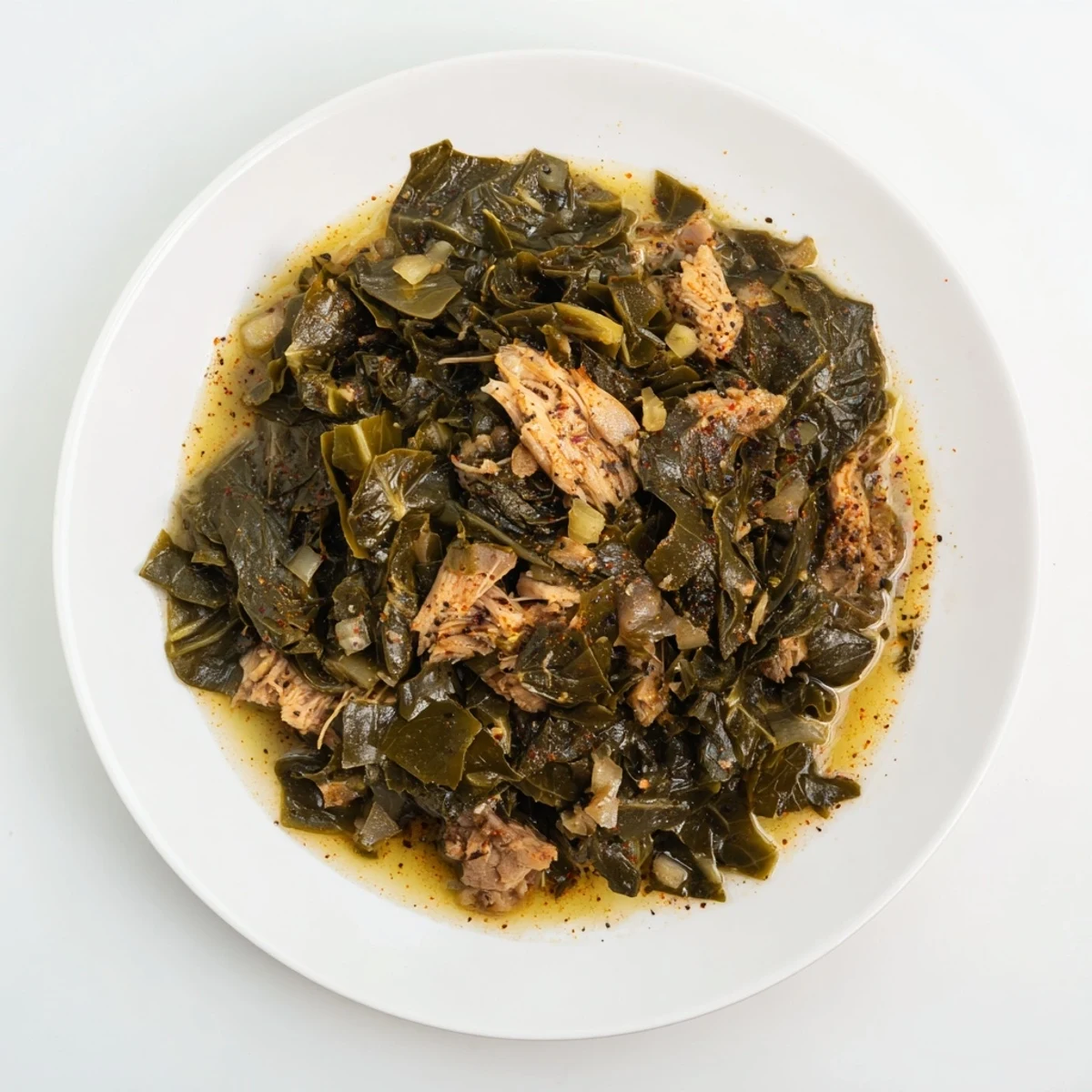 A steaming bowl showcasing Southern style collard greens with chunks of flavorful smoked turkey throughout.