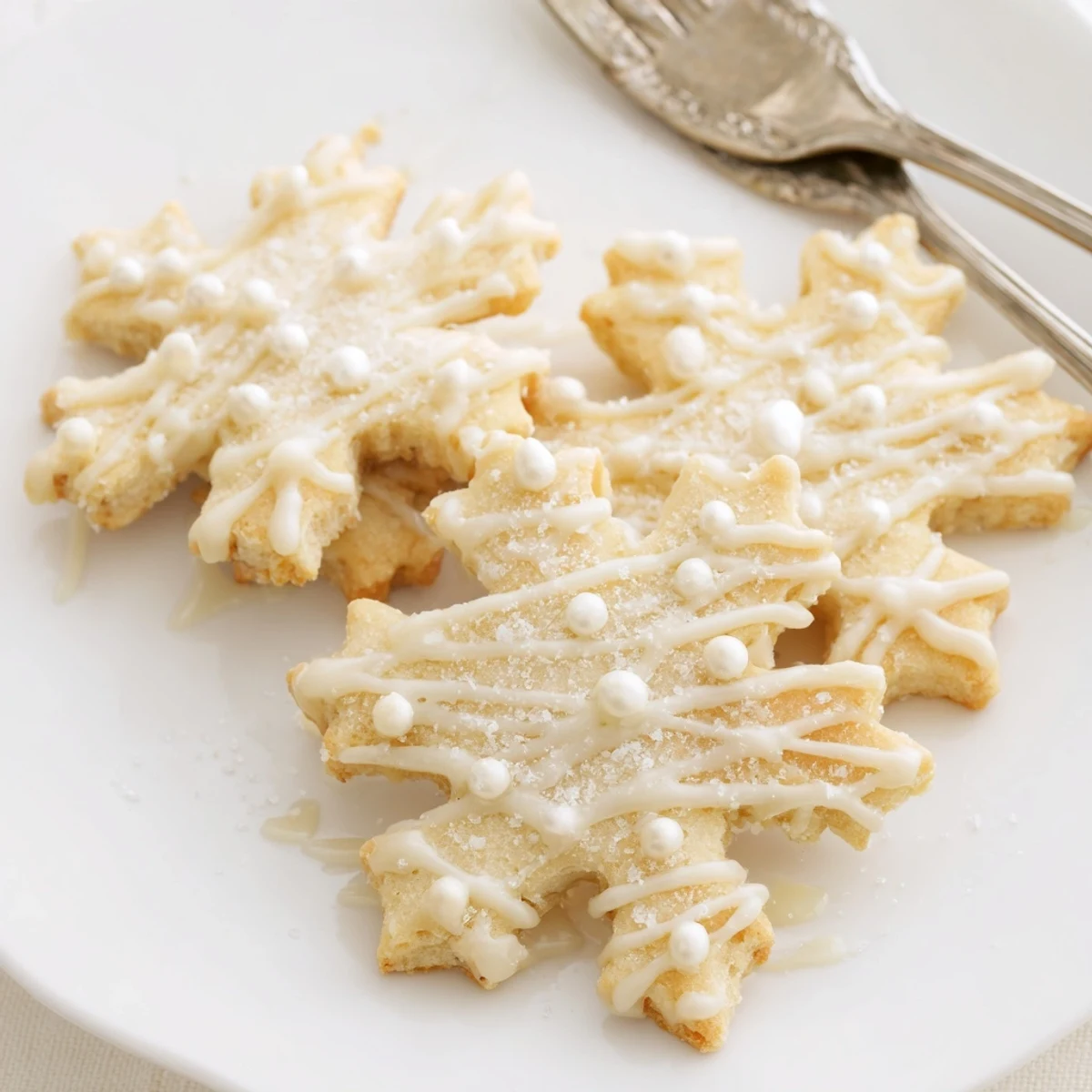 Golden-edged Winter Snowflake Platter cookies, dusted with icing sugar, ready for a winter treat.
