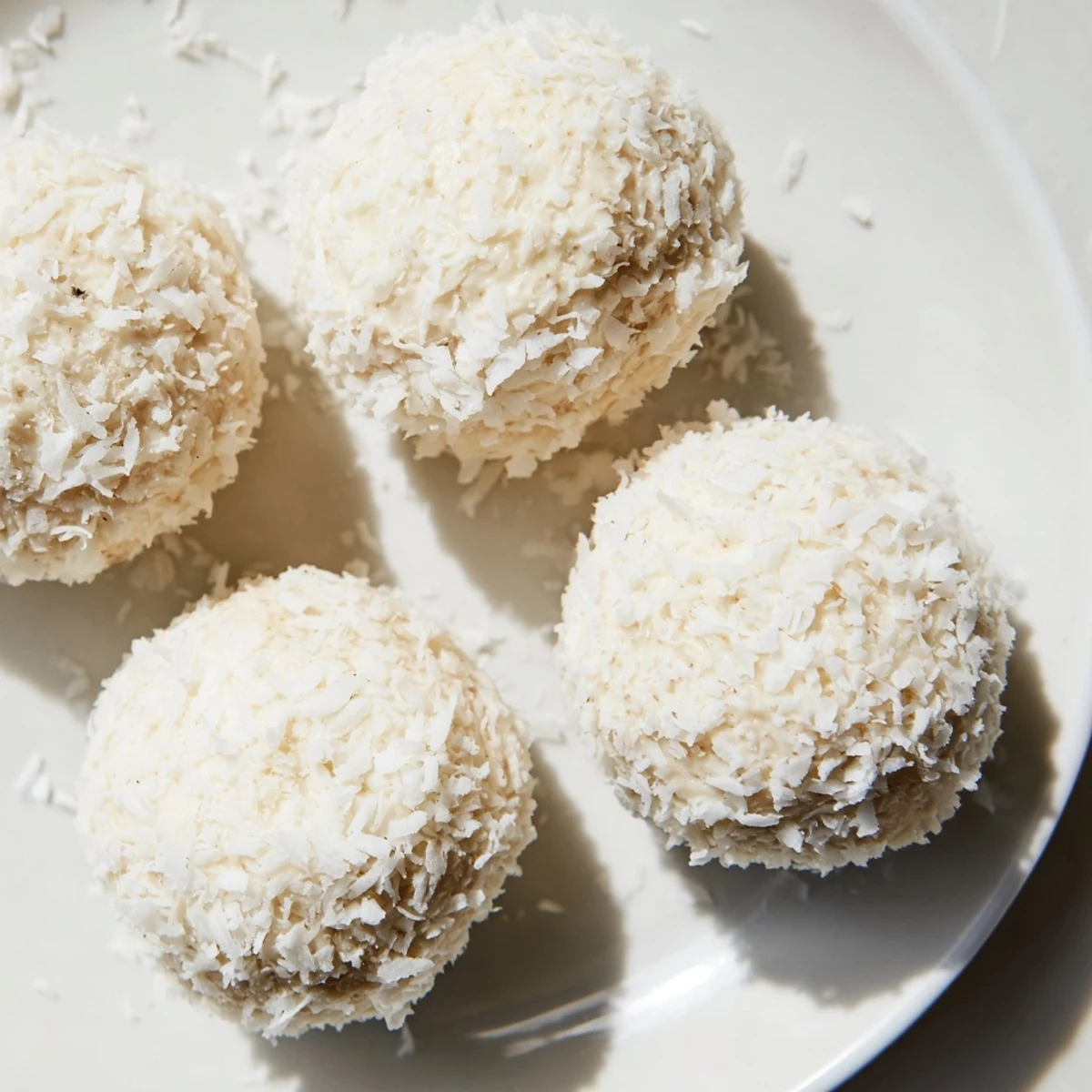 Creamy Marshmallow Snowball Dip Platter, a delightful dessert with fresh fruit alongside coconut snowballs.