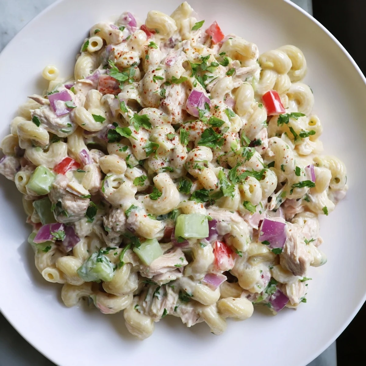 Close-up of a bowl filled with chilled Chicken Macaroni Holiday Salad, a delicious and easy side dish.