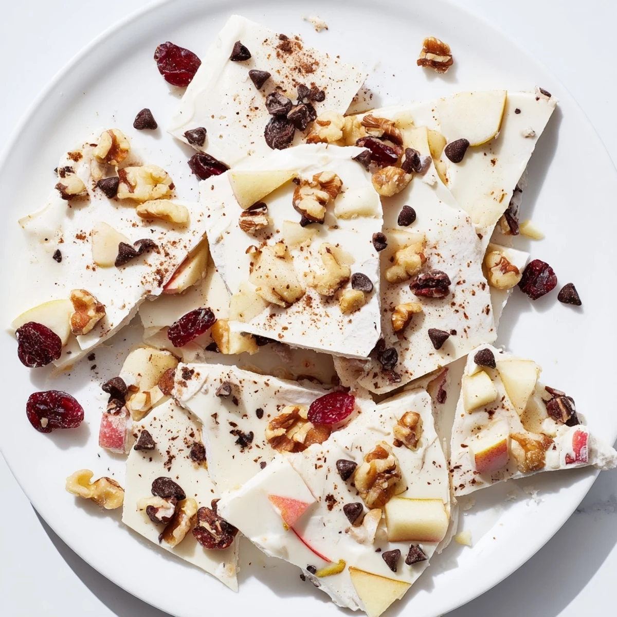 Creamy Apple Cinnamon Yogurt Bark boasts fresh apples and crunchy nuts for a frozen treat.
