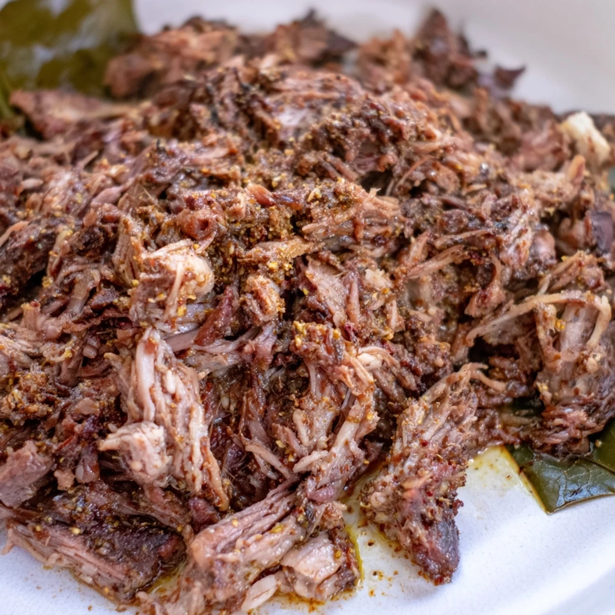 Tender Omani Shuwa meat, fall-apart texture, with vibrant spices steaming on a platter.