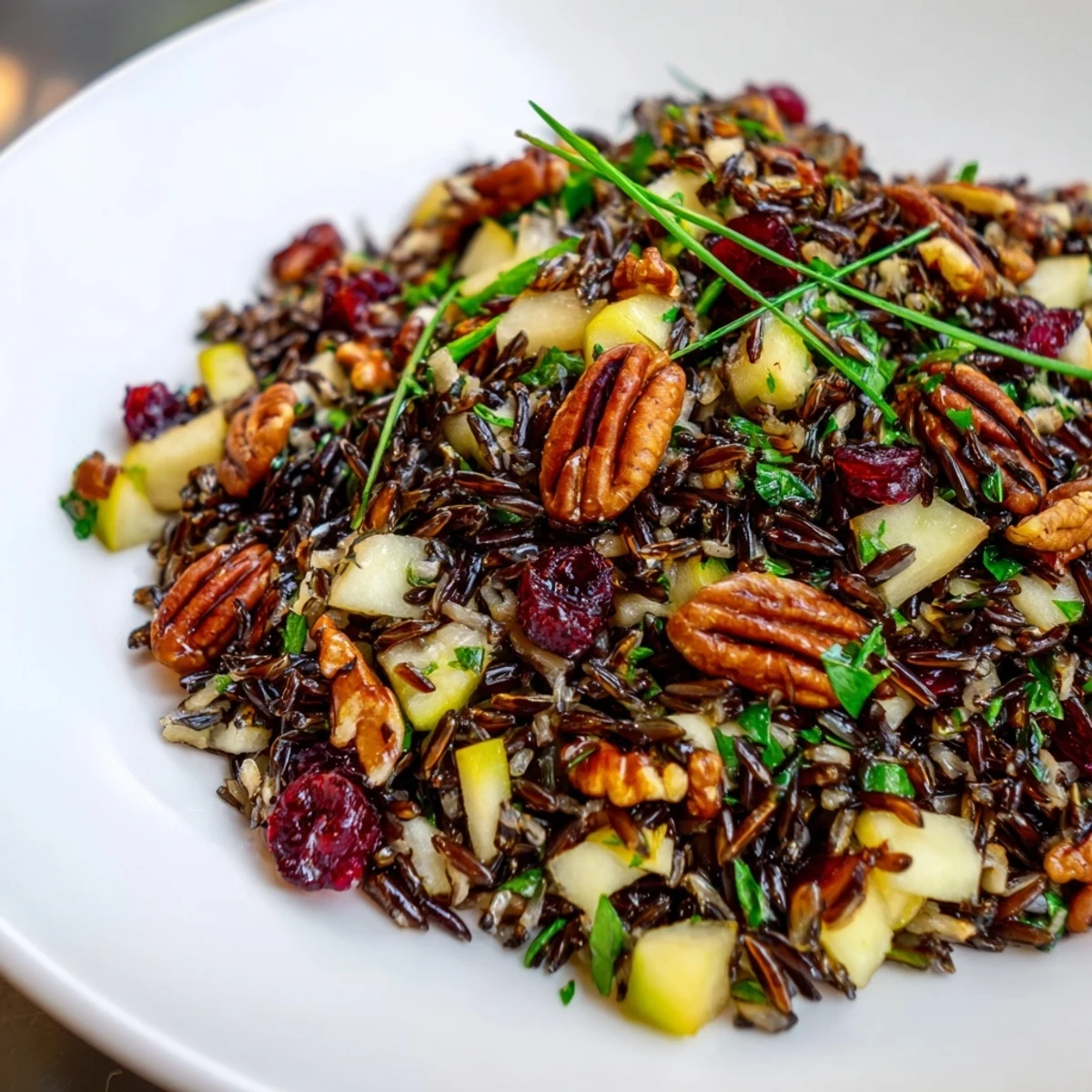 A colorful wild rice harvest salad, dotted with cranberries and toasted pecans, ready to serve.