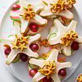 Ocean-themed Beach Day Starfish snacks with adorable starfish sandwiches surrounded by colorful fruits and veggies.