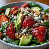 Refreshing strawberry avocado quinoa salad tossed in zesty citrus dressing with toasted almonds and basil.  