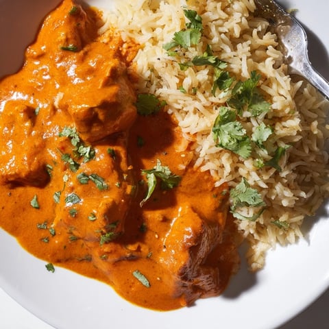 Tender butter chicken served in a creamy tomato sauce with aromatic rice pilaf.  