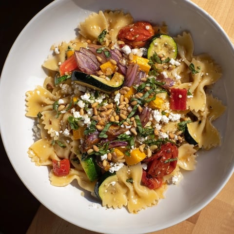 Bow tie pasta platter with roasted vegetables, a beautiful and vibrant Italian main course.