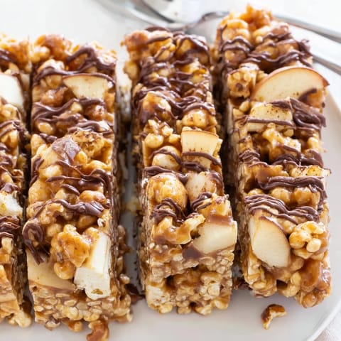 Crunchy popcorn mingles with dried apples in these sweet caramel apple popcorn bars.  