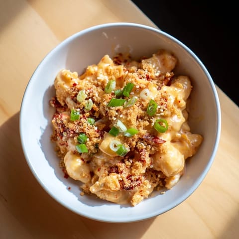 Bold Spicy Kimchi Mac & Cheese with melty cheeses and zesty flavors, perfect for gatherings.  