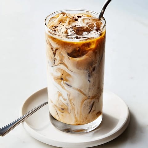 Rich and refreshing Tahini Iced Coffee topped with plant-based milk and sweetness.  