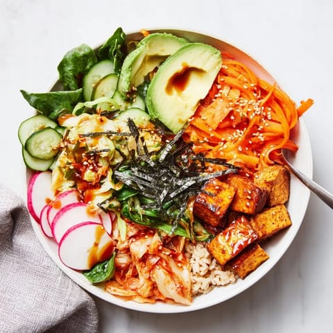 Vibrant fermented vegetable bowl with creamy avocado, kimchi, and nutritious grains.  