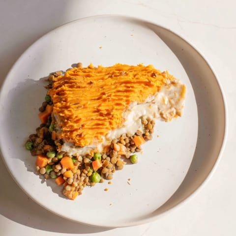 Golden-topped Veggie Shepherd's Pie with a rich lentil filling, savory and satisfying on the plate.