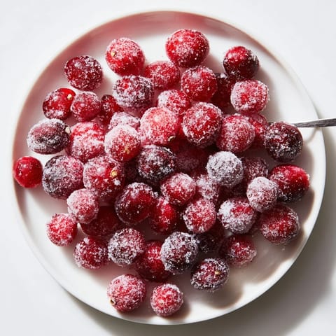 Sweet, ruby-red vegan candied cranberries, coated in sparkling sugar, perfect for cocktails.