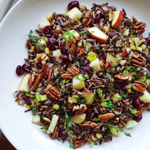 Tender wild rice harvest salad, tossed with vibrant herbs and a tangy vinaigrette, perfect for autumn.