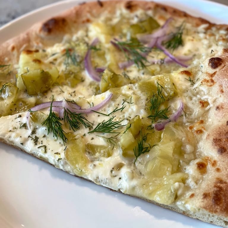 Deliciously unique pickle pizza topped with rich crème fraîche and crispy dill pickles.  