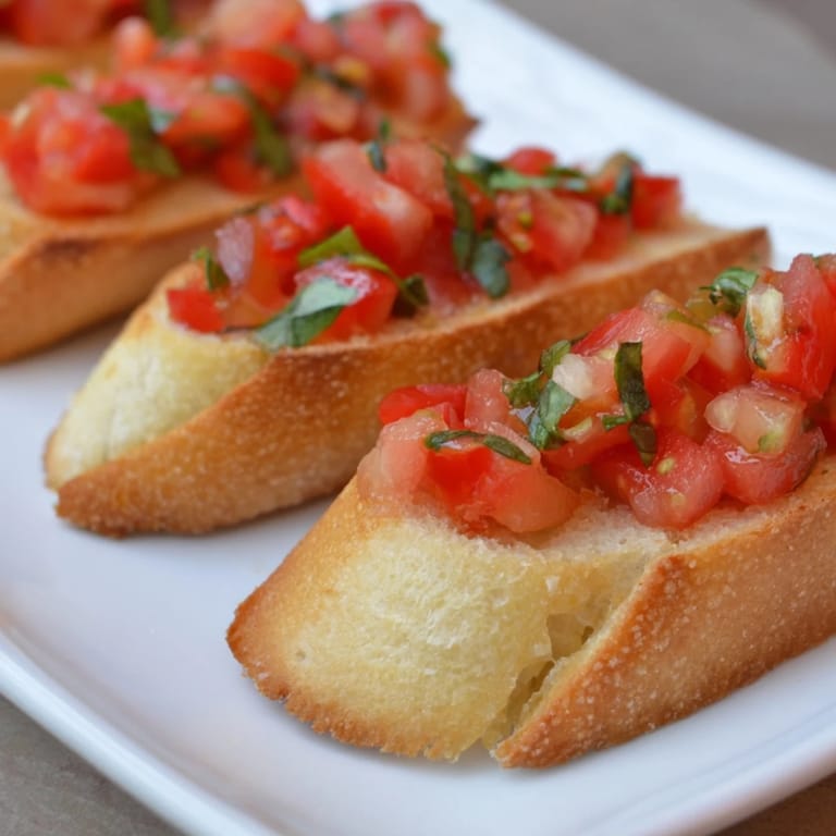 Close-up of freshly prepared Bruschetta toasts, featuring ripe tomatoes and herbs, a classic Italian appetizer.