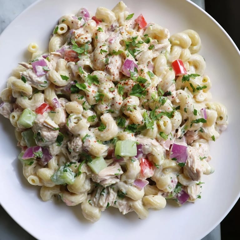 Close-up of a bowl filled with chilled Chicken Macaroni Holiday Salad, a delicious and easy side dish.
