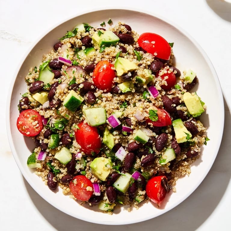 This refreshing Quinoa Black Bean Salad features creamy avocado and a zesty lime dressing, perfect for lunch.