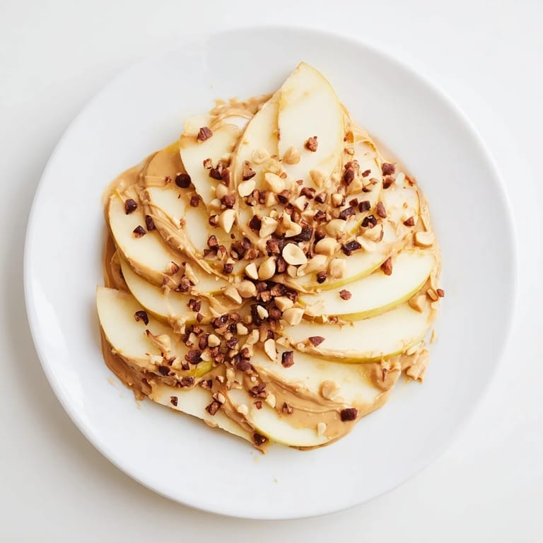 A plate of colorful peanut butter apple nachos, drizzled with honey, ready to eat and enjoy.