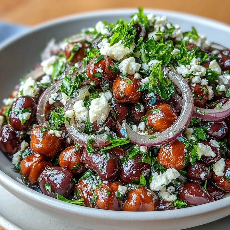 Vibrant Mediterranean Divorce Salad in a white bowl, featuring marinated beans, tangy feta, and crunchy onions, ready to serve for lunch.